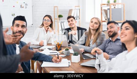 Business colleagues listening to presentation at conference Stock Photo