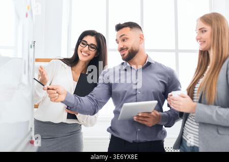 Confident colleagues discussing new project in office Stock Photo