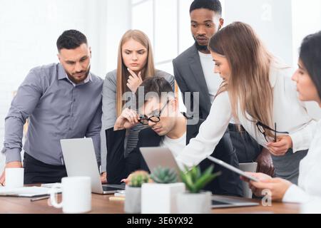 Diverse business team analyzing financial report at meeting Stock Photo