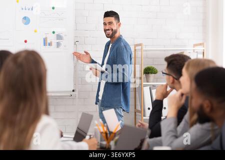 Business coach giving presentation to managers team Stock Photo