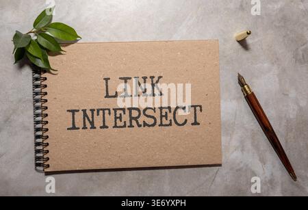 Link intersect business seo concept text on a white notebook and hourglass clock, green leaves of flowers Stock Photo