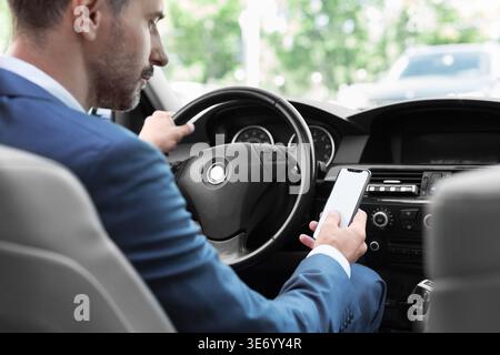 Businessman using mobile phone in traffic jam Stock Photo
