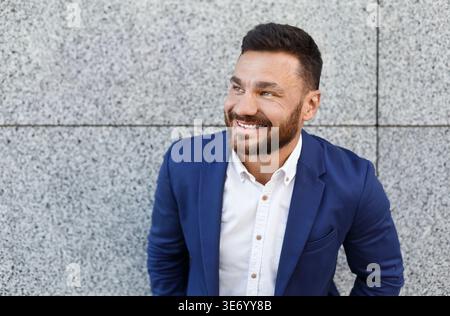 Successful businessman standing in front of office building Stock Photo