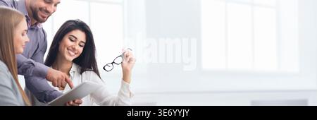Happy business colleagues discussing new project in office Stock Photo