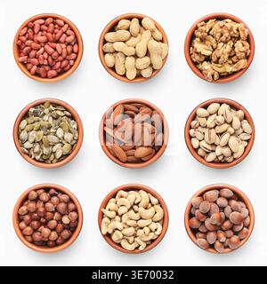 Set of various nuts in ceramic bowls isolated on white Stock Photo