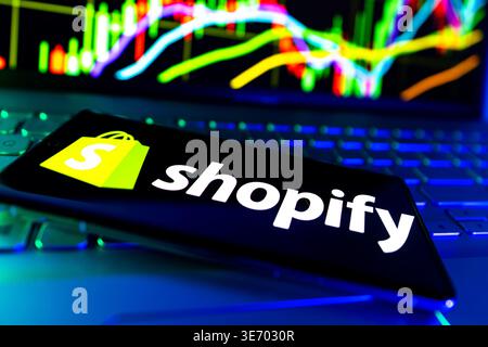 Shopify E Commerce Platform Technology Company Logo Displayed On Screen With Online Retail And Stock Market Performance Data Background Stock Photo