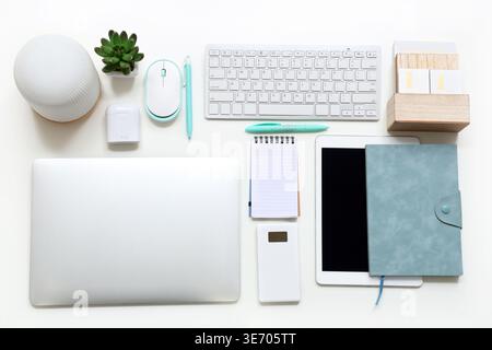 Different gadgets with notebooks on white background Stock Photo