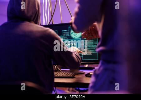 Criminals hacking computer network system successfully and getting access granted message on screen. Hackers breaking into server to steal valuable information while doing illegal activities Stock Photo