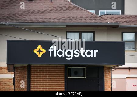 South bend, IN, USA -April 03, 2026: Flagstar Bank sign and logo displayed on the brick building exterior Stock Photo