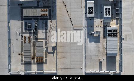 Aerial view showing industrial ventilation and climate control units on building roof of a data center. Stock Photo