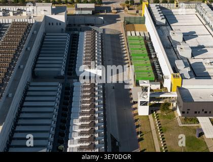 Aerial view showing a large industrial server farm facility with numerous cooling units Stock Photo