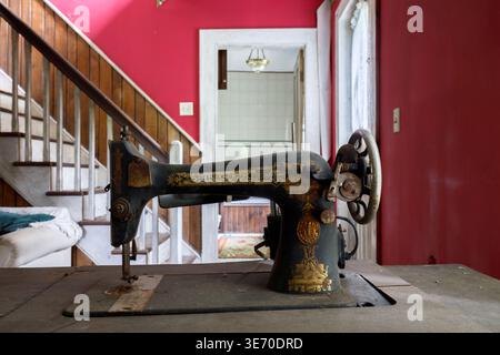 An antique Singer sewing machine from the early 1900s covered in dust, dirt and rust. Stock Photo