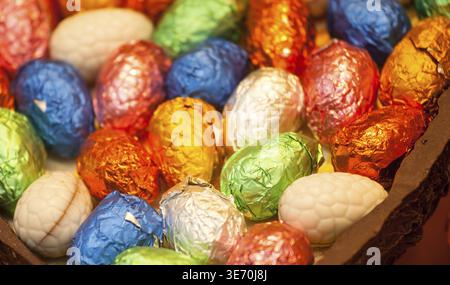 Multicolored foil wrapped easter eggs inside chocolate egg Stock Photo