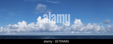 High resolution panoramic cloudscape of sunny clouds over the ocean Stock Photo