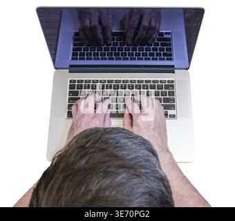 Senior caucasian adult man types on modern keyboard of laptop or ultrabook on isolated white background or desk Stock Photo
