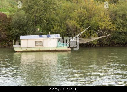 Small houseboat on side of River Danube used for fishing near Vienna, Austria Stock Photo