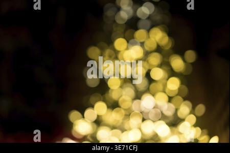 Defocused bokeh of christmas tree lights to be used as abstract background for holiday image Stock Photo
