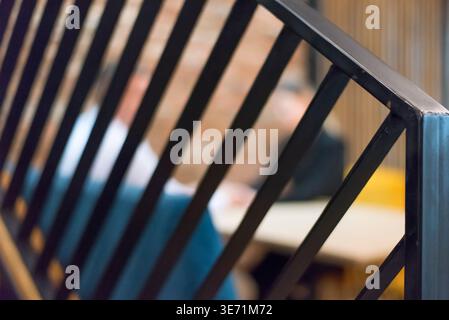 Two professionals having a private business conversation in a modern office. Concept of trust, negotiation, coaching, partnership and communication. Stock Photo