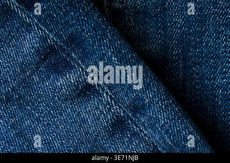 Detailed blue denim fabric texture background with visible stitching pattern Stock Photo