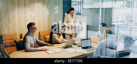 Team engaging in creative activity using whiteboard and sticky notes Stock Photo