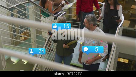 Descending team in work clothes holding phone laptop files on stairs by metal rails showing 15 or 24 or 5. Multilevel, glass, handrail, collaboration, Stock Photo