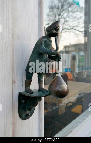 Door knocker glassblower figure Stock Photo