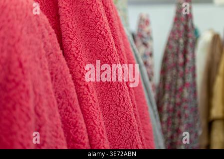 A close up view of a vibrant pink sherpa fleece fabric. Stock Photo
