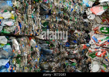 Large bales of compressed plastic bottles ready for recycling and reuse Stock Photo