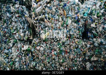 Massive bales of compressed plastic bottles ready for recycling and reuse Stock Photo