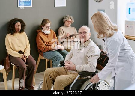 Portrait of Senior Man with Disability Waiting in Medical Clinic Stock Photo