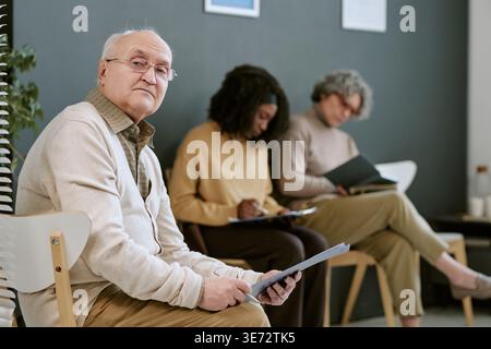 Portrait of Senior Man Waiting in Group Therapy Session Stock Photo