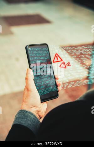 Cyberattack warning on smartphone with data breach alert and binary code overlay. Mobile security threats and data breaches. Stock Photo