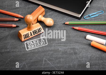 TAKE A BREAK. Message Shown With Wooden Stamp And Stationery On Work Desk Stock Photo