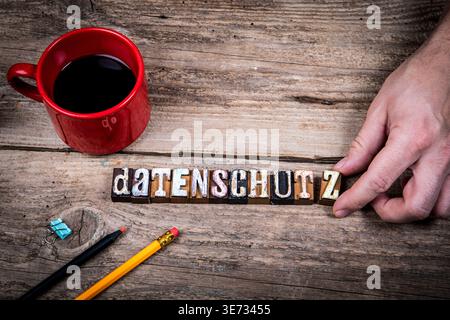 Data Protection Concept With German Word DATENSCHUTZ on Rustic Wooden Workspace Stock Photo