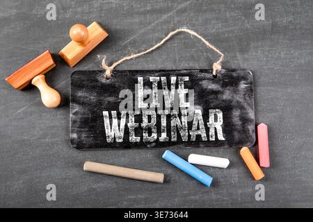 Live Webinar Written On Chalkboard Sign With Stamps And Chalk Pieces Stock Photo