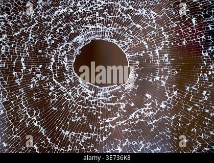 Glass pane, safety glass, broken glass, shattered, hole caused by a stone throw Stock Photo