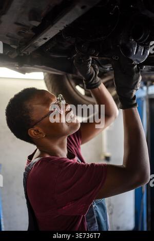 Young female mechanic repairing car in a garage Stock Photo