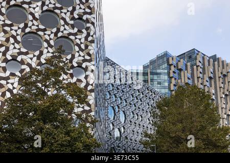 Modern building facade with geometric metal ring patterns Stock Photo