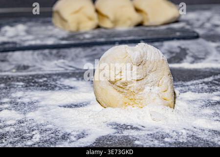 A Close-Up of Freshly Prepared Dough Sitting on a Flour-Dusted Surface, Accentuating the Texture and Ingredients for Homemade Baked Goods. Stock Photo