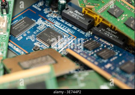 Pile of computer hardware components including RAM and circuit boards highlighting e-waste and technology recycling concept Stock Photo