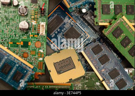 Pile of computer hardware components including RAM and circuit boards highlighting e-waste and technology recycling concept Stock Photo