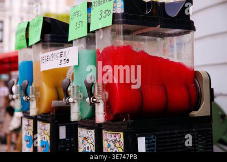 Villach, Austria - July 30, 2025: Vibrant slushie machines display colorful flavors at Villacher Kirchtag, inviting visitors to enjoy refreshing summe Stock Photo