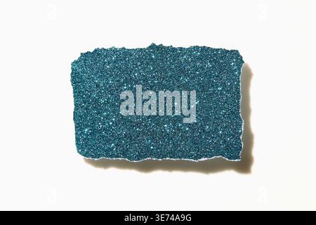 Torn blue glitter paper on white background Stock Photo