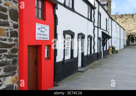 Conwy, Wales, UK - March 26, 2026; Row of houses in Conwy including red Smallest House in Great Britain Stock Photo
