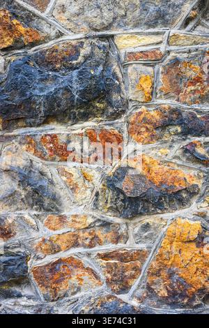 Background texture of constructed stone wall using large natural colored rocks Stock Photo