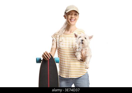 Young female posing with a longboard and dog isolated on white background Stock Photo