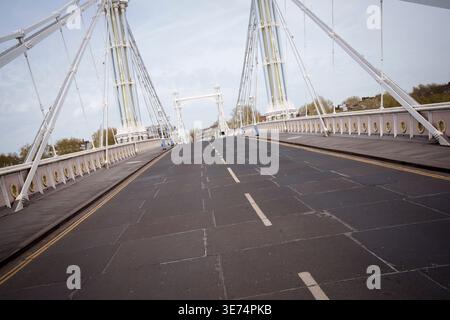 Following the decision by Kensington & Chelsea council to close the 150 year-old Albert Bridge to traffic - and also this week, to pedestrians and cyclists, the empty highway is seen from the southern end of the bridge, on 9th April 2026, in London, England. The Grade II listed Albert Bridge (1873) which connects Battersea to Chelsea has been closed to traffic as a precautionary measure following a routine structural inspection by engineers. The closure follows the similar closure of Hammersmith Bridge, therefore causing even more traffic disruption in west London. Albert Bridge is, along with Stock Photo