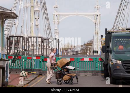 Following the decision by Kensington & Chelsea council to close the 150 year-old Albert Bridge to traffic - and also this week, to pedestrians and cyclists, barriers block access to the southern end of the bridge, on 9th April 2026, in London, England. The Grade II listed Albert Bridge (1873) which connects Battersea to Chelsea has been closed to traffic as a precautionary measure following a routine structural inspection by engineers. The closure follows the similar closure of Hammersmith Bridge, therefore causing even more traffic disruption in west London. Albert Bridge is, along with Tower Stock Photo