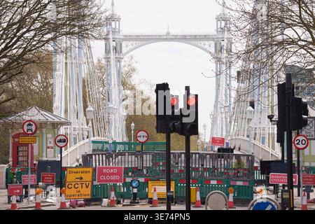 Following the decision by Kensington & Chelsea council to close the 150 year-old Albert Bridge to traffic - and also this week, to pedestrians and cyclists, barriers and cones block access to the northern end of the bridge, on 9th April 2026, in London, England. The Grade II listed Albert Bridge (1873) which connects Battersea to Chelsea has been closed to traffic as a precautionary measure following a routine structural inspection by engineers. The closure follows the similar closure of Hammersmith Bridge, therefore causing even more traffic disruption in west London. Albert Bridge is, along Stock Photo