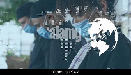 Diverse kitchen staff standing in line, African American chef wearing towel, masks, map, copy space. Team, cooks, culinary, global, infographic, brigh Stock Photo